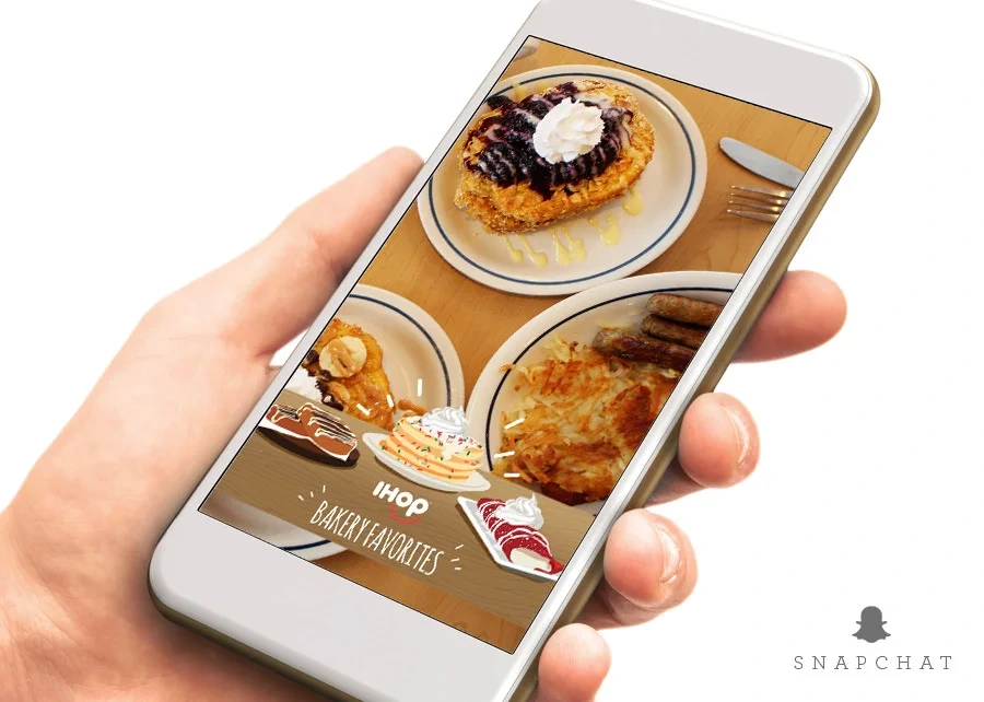 Bakery Favorites Snapchat filter on a phone held over IHOP dishes